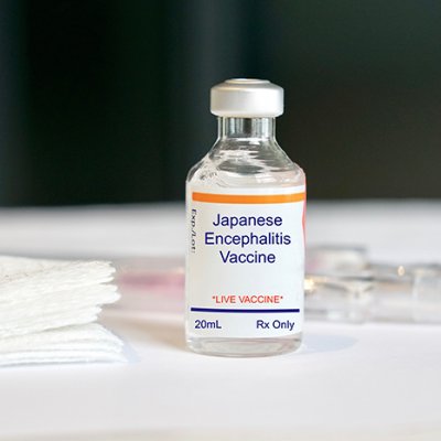 Vital of Japanese encephilities vaccine on a white table with label clearly visible  